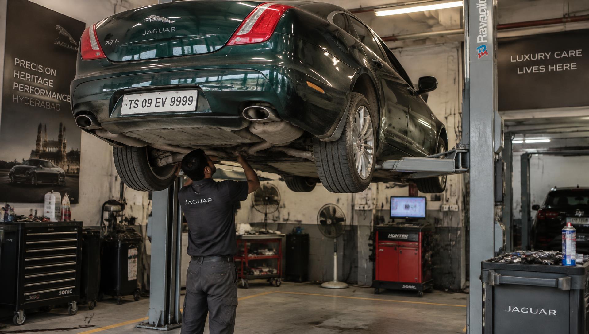 Jaguar car on a lift being serviced in our Hyderabad workshop